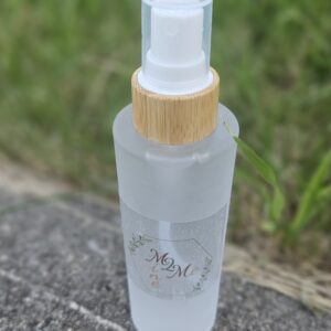 Frosted spray bottle on outdoor surface.