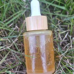 Dropper bottle on grass background.