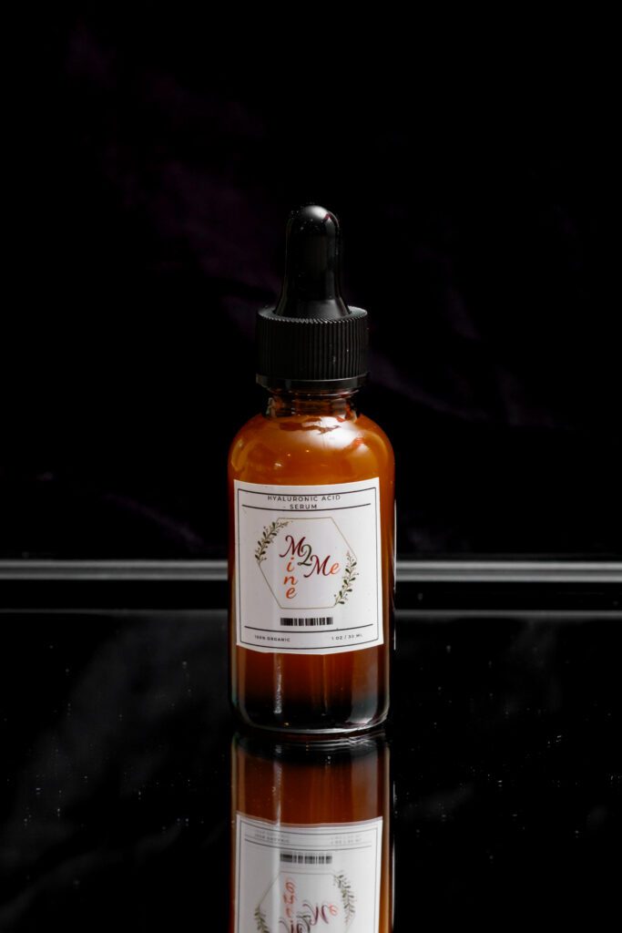 Amber bottle with dropper on black background.