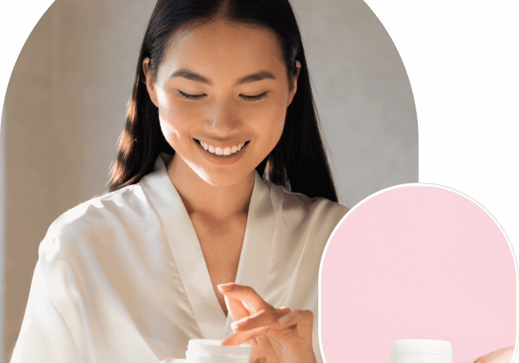 Woman applying cream from a small jar.